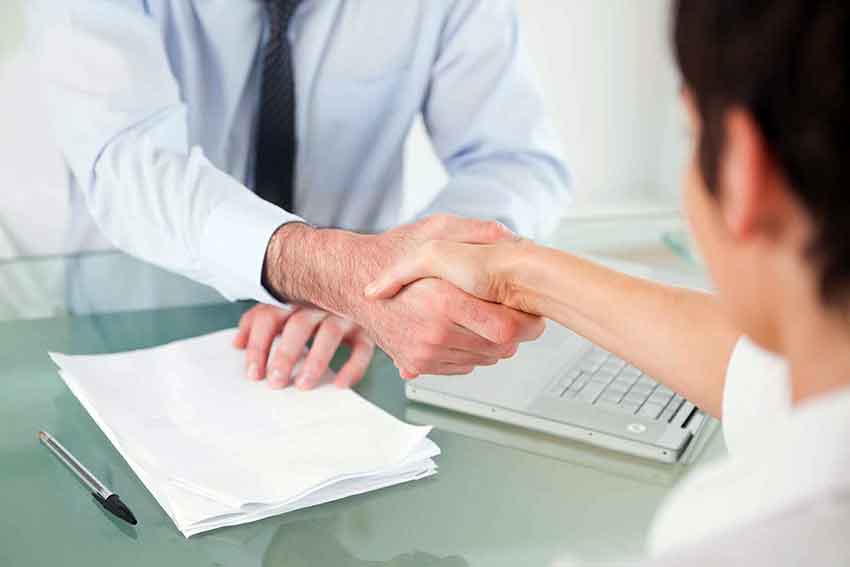 Lawyer-client-shake-contract-med Lawyer shakes client's hand after successful settlement